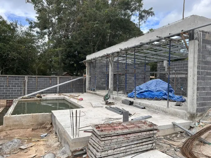 Roof steel on a villa frame, with the pool formed in front
