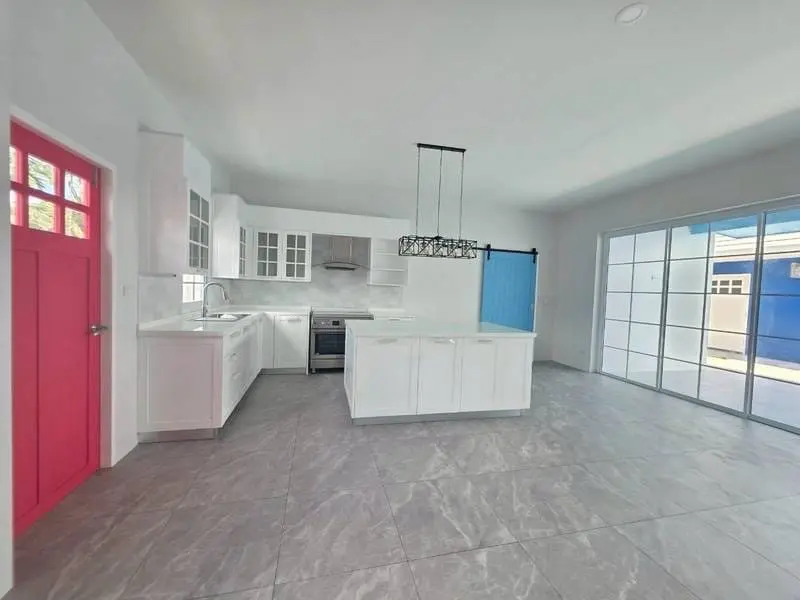 Kitchen with island unit and red entrance door